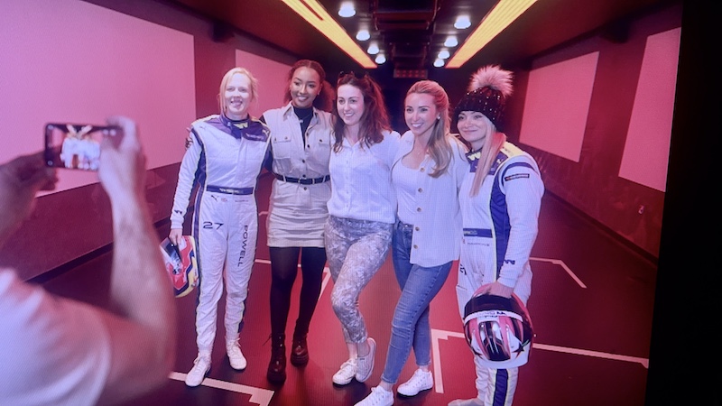 Georgina Sadler in a behind the scenes shot with four other women in motorsport