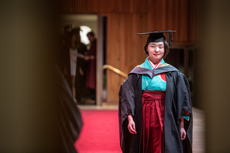 A UCA graduand takes the stage in traditional dress