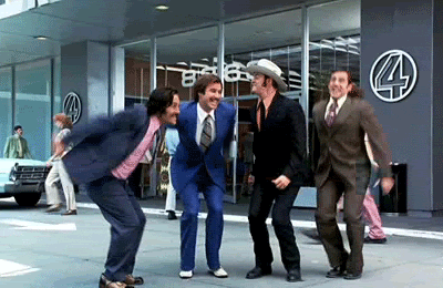 Characters from Anchorman leap into the air with joy