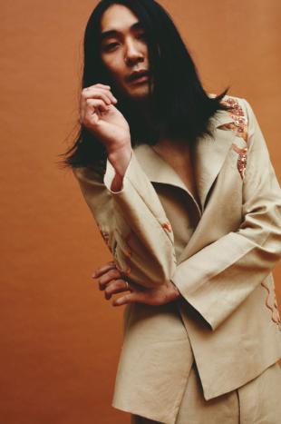 Model wears beige embroidered tailoring